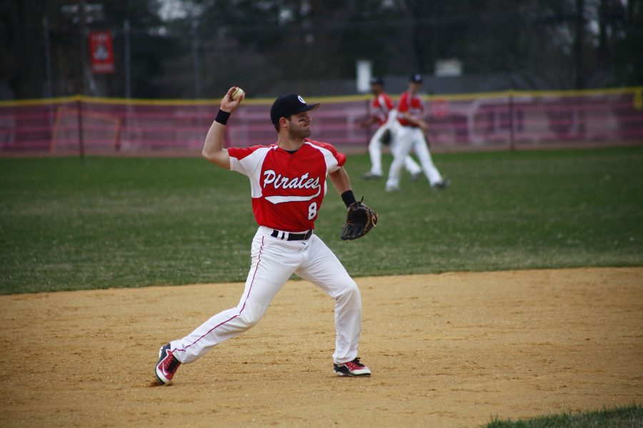 Junior Dom Cicale fires the ball from shortstop while warming up prior to a game.
