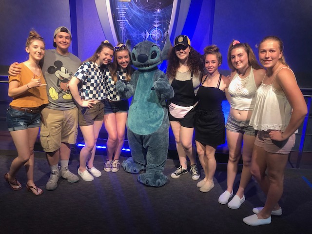 Mikaela and her friends pose for a photo with Stitch from Disneys Lilo and Stitch