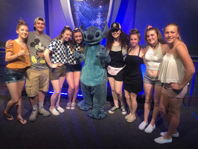 Mikaela and her friends pose for a photo with Stitch from Disney's Lilo and Stitch