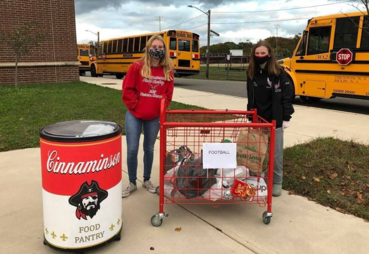Freshman Sam Keeports and Junior Grace Coller, the students leaders of the CHS Food Pantry, collect food at a Pirates home football game. 