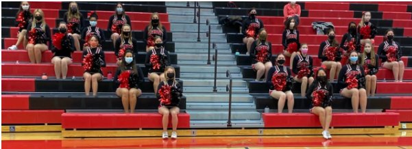 The girls sit socially distanced in the stands for their cheers. Photo courtesy of Coach Kramer and Coach Lamb