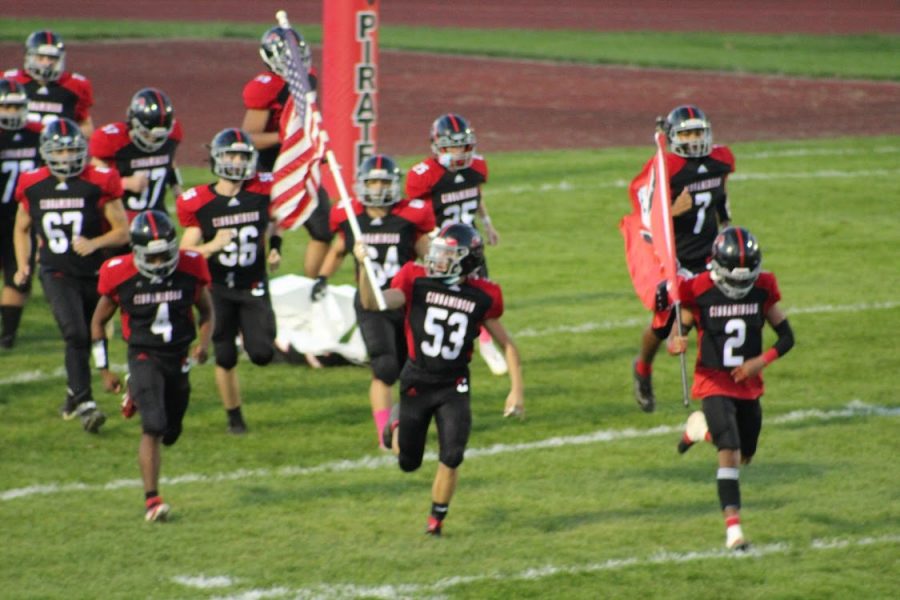 The football team runs out onto the field before their game (photo courtesy of CHS football)