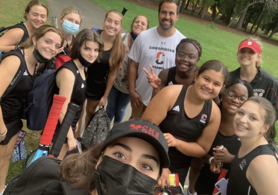 The tennis team smiles with their coaches Mrs. Alvarado and Mr.Perekupka (photo courtesy of the tennis team)