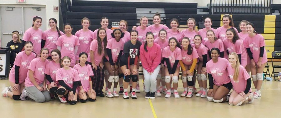 Photo+courtesy+of+Coach+Mooney.+The+varsity+team+%28on+the+left%29+with+Moorestowns+varsity+team+after+our+recent+Breast+Cancer+fundraiser+event.+%0A