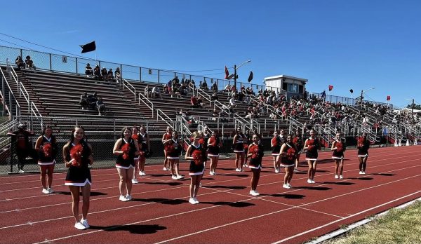(Photo Courtesy of Brian Wilkinson) The cheer team boosts morale during a football game