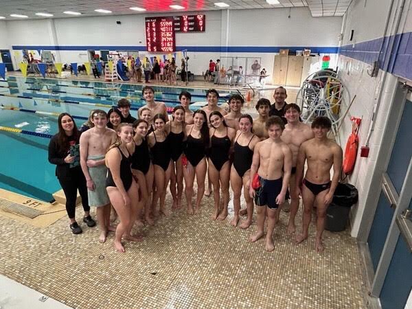 (Photo Courtesy of the Cinnaminson Swim Team) The Pirates swim team poses for a group picture with Head Coach Collin Canfield after a recent win.