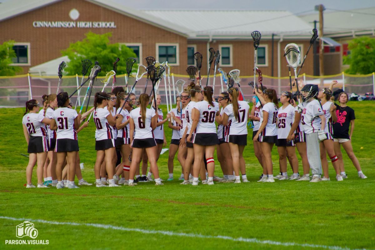 (Photo Courtesy of Chase Parson) The girls lacrosse team cheers before the start of their game.