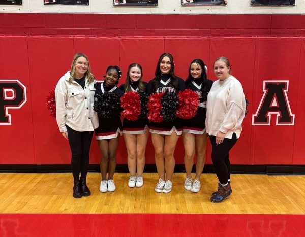 (Photo courtesy of Kalleigh Trost) Cheer coaches recognize seniors Oluwabukola Mustapha, Kalleigh Trost, Eliza Jeffries, and Jordan Welsh. 