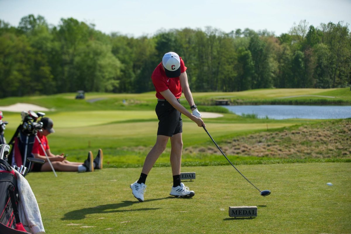 (Photo courtesy of the Buccaneer)  Freshman Jackson Lane tees off from the teebox. 