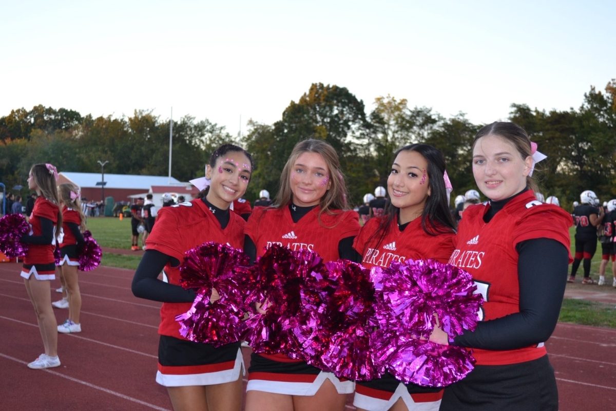(Photo courtesy of  Patricia  Ruggieri) Senior cheer captains Evelyn Souza- Silva, Ryan Cartony, Olivia  Ruggieri and Marissa Daniels smile to for their senior night of their fall cheer leading season. 