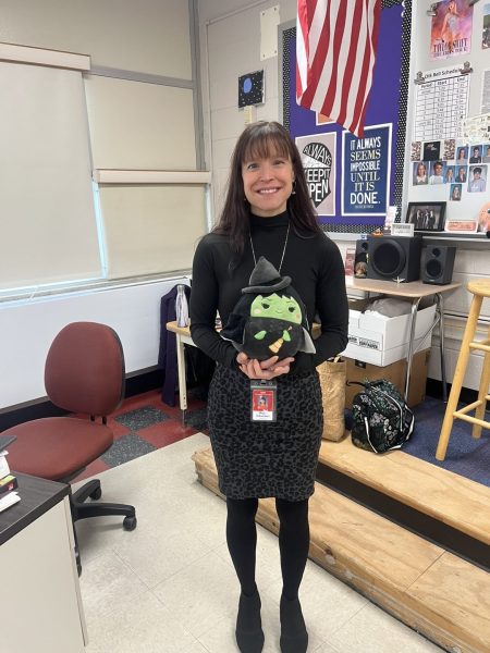 (Photo courtesy of Zack Bohn) Mrs. Schweitzer, CHS history teacher and advisor of the drama club, happily poses with her own Wicked merchandise.  