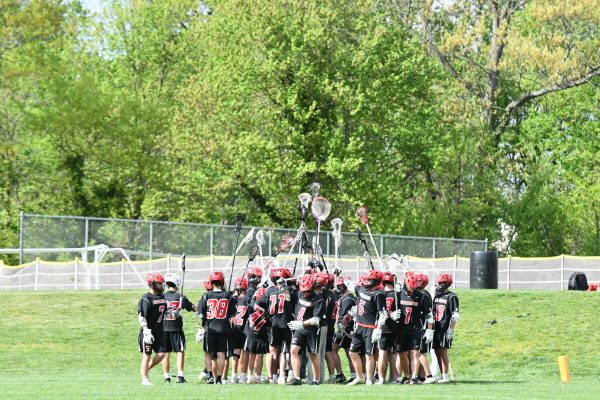 (Courtesy of The Buccaneer) During the game, the boys' lacrosse team celebrates a victorious goal. 